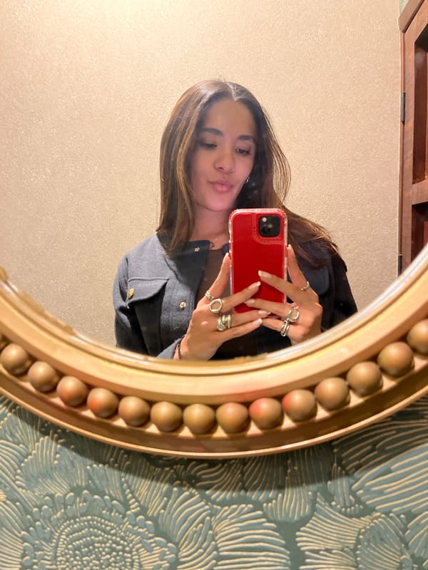 Woman takes morning selfie in decorative gold mirror
