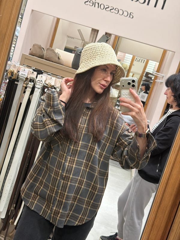 Woman takes mirror selfie in accessories store in Perm