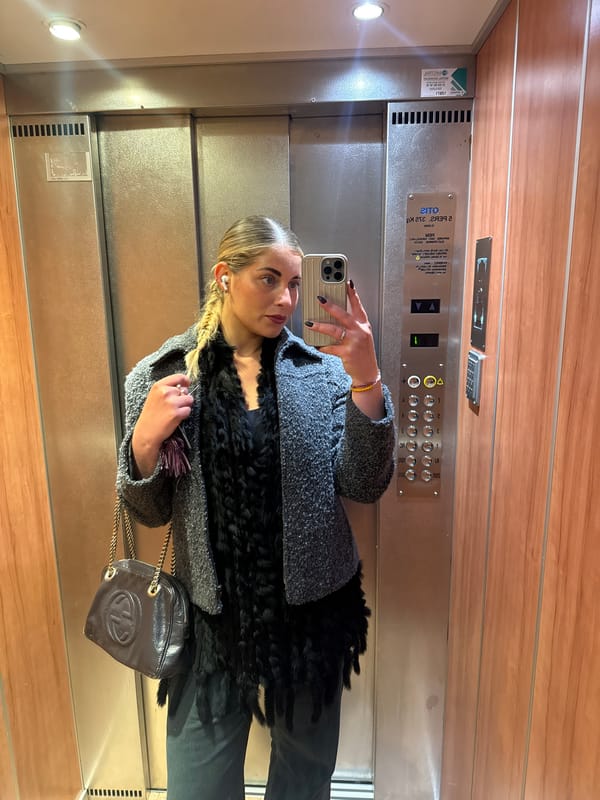 Woman takes selfies in Parisian elevator