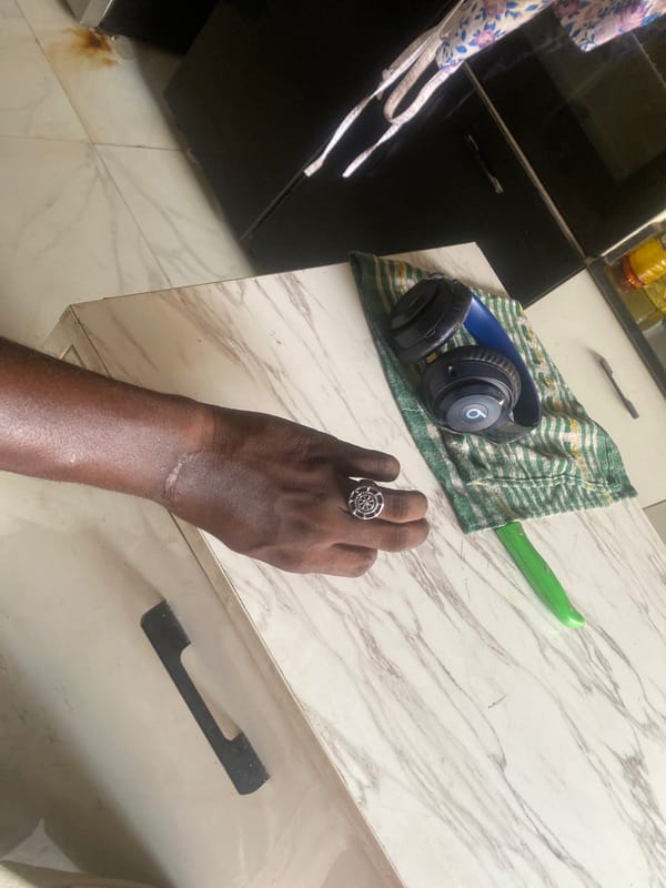 Domestic moment captured in Lagos showing hand with ring