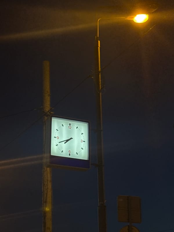 Moscow evening scenes captured at dusk with street clock