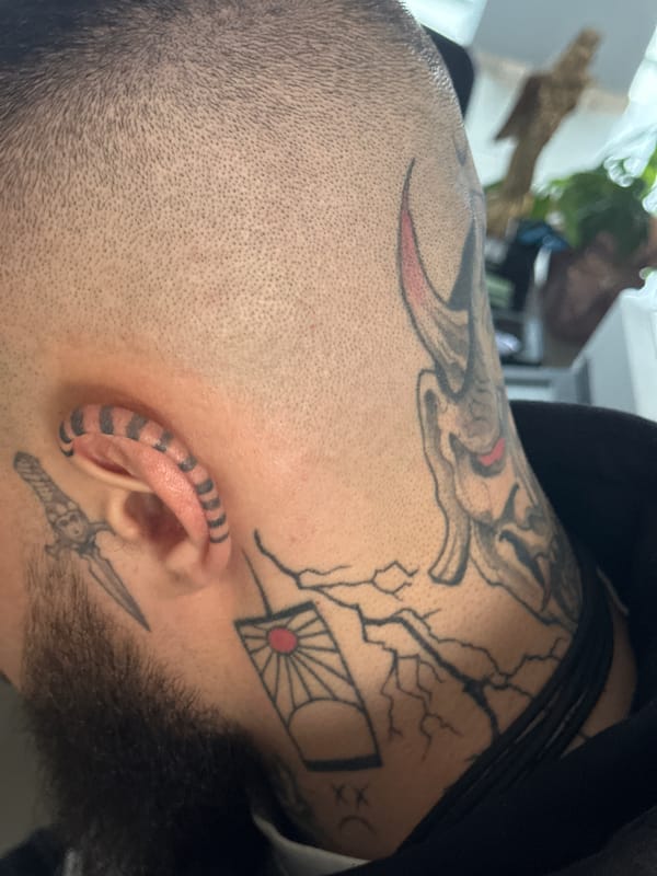 Tattooed individual with dragon artwork photographed in Sofia