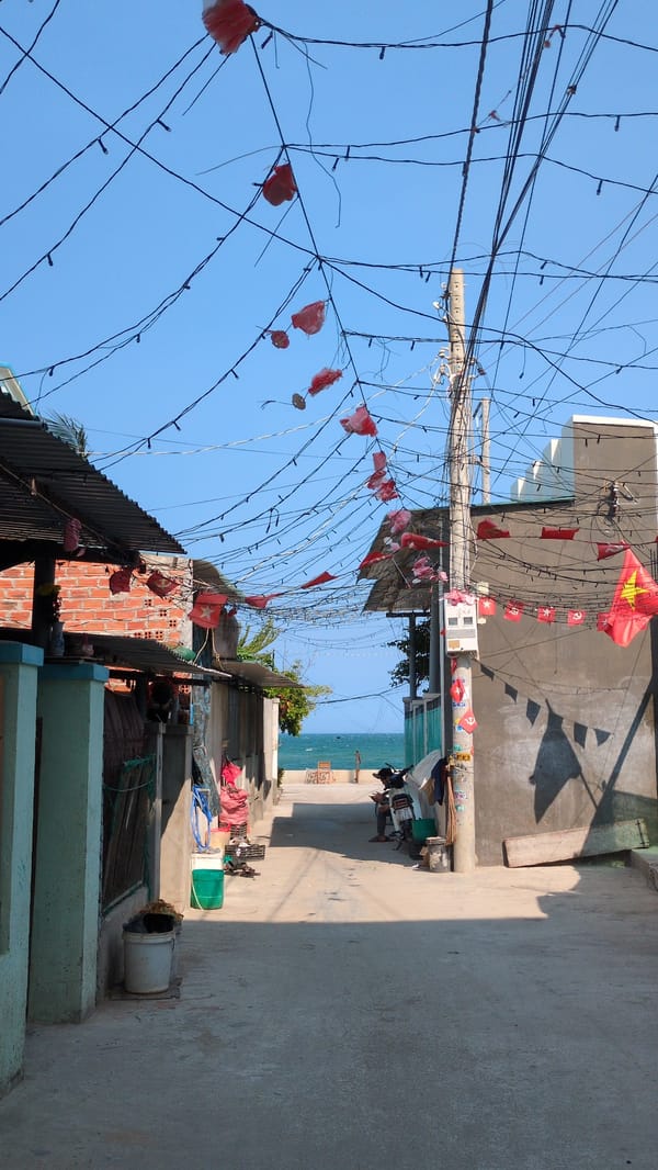 Red flags adorn electrical wires in Vietnamese coastal town