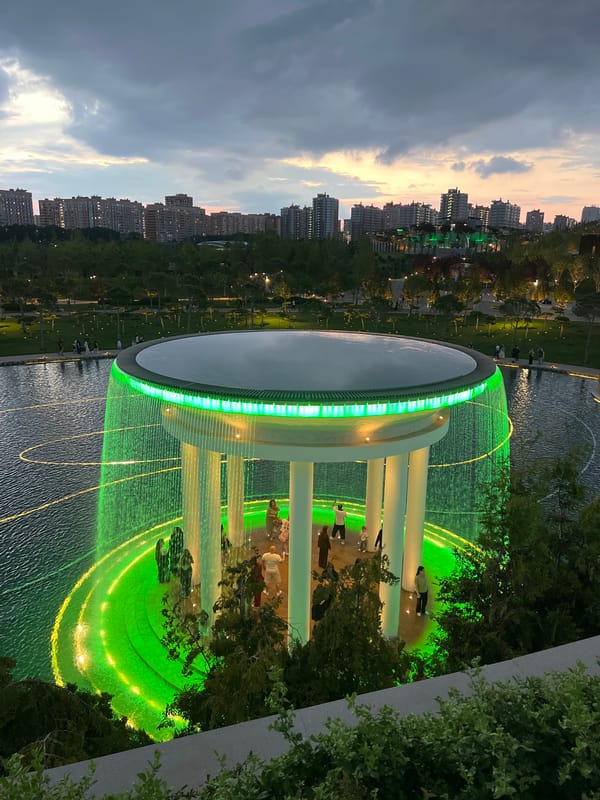 Evening park walk in Krasnodar featuring globe sculpture