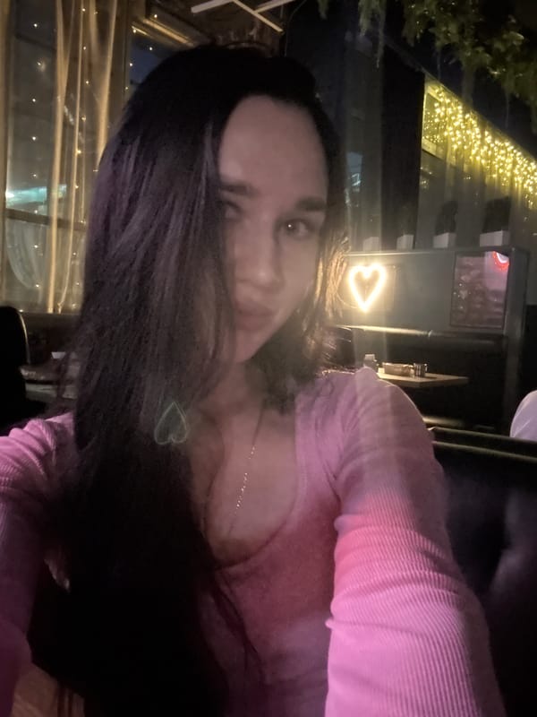 Evening at a neon-lit Novosibirsk bar with food, drinks, and dancing
