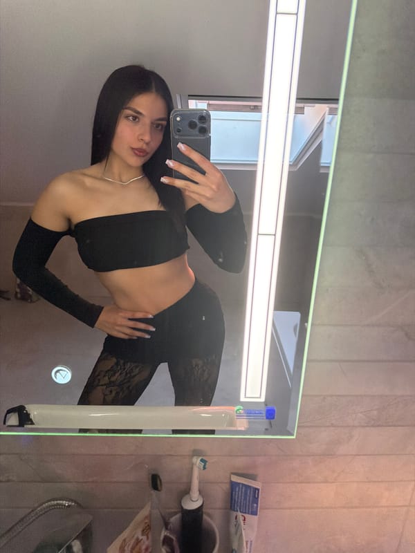 Woman takes bathroom mirror selfies in Gabrovo, Bulgaria