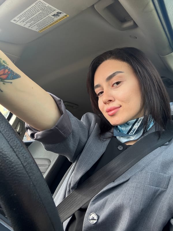 Woman in gray blazer spotted in car, elevator in Tbilisi