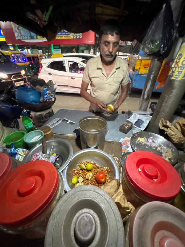 Street vendor prepares food in Kolkata during afternoon hours