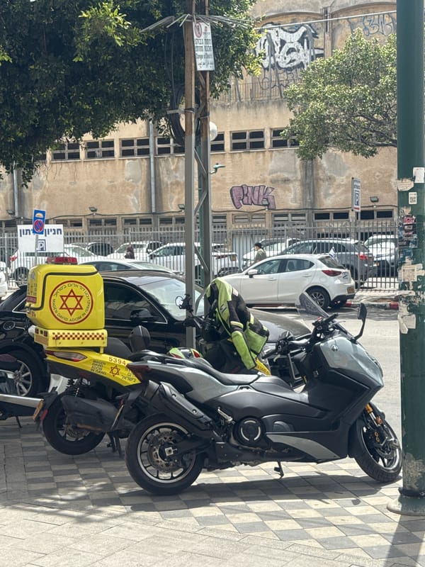 Scooter parked on sidewalk in Netanya street scene