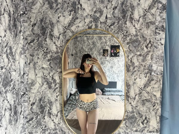 Mirror selfie in a gold-framed oval mirror, Moldova bedroom