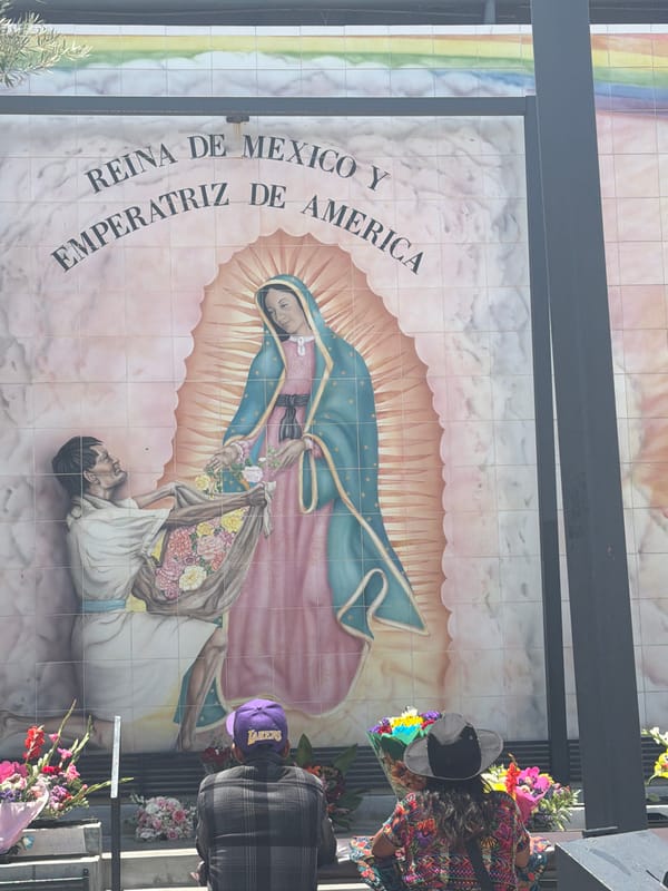 Visitor documents historical markers at El Pueblo monument