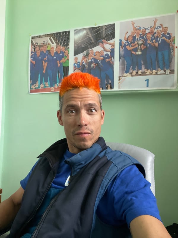 Man sits by sports posters in Chaikovsky home