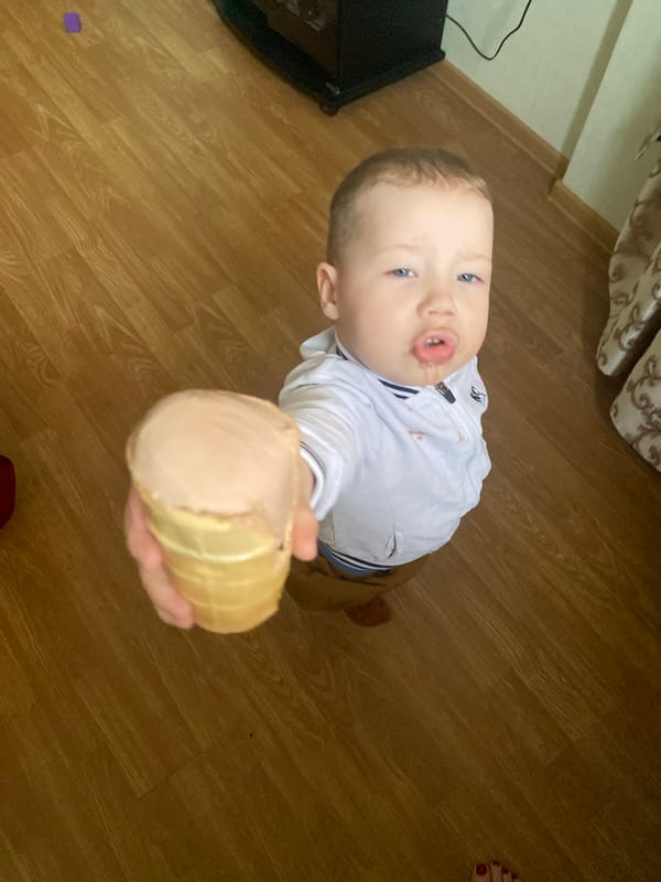 Child enjoys ice cream amid everyday Sochi street scenes