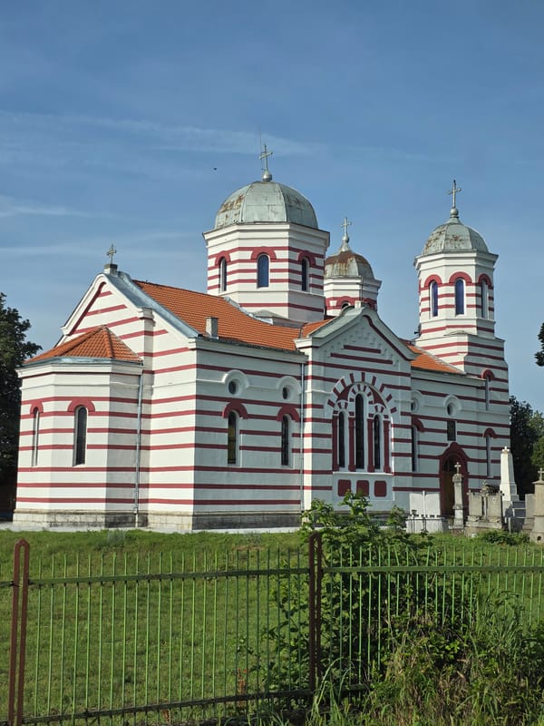 Distinctive striped church with multiple domes observed by witness