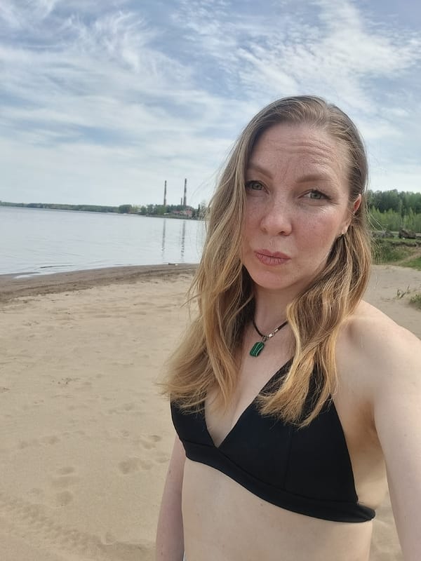 Woman sunbathes on Kama River beach in Chaikovsky, Russia