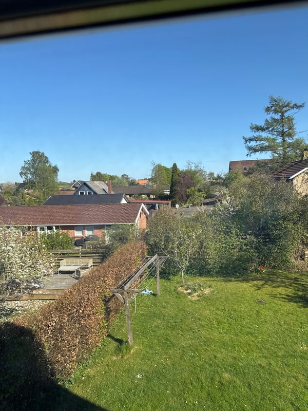 Clear skies observed over suburban Lejre neighborhood from window