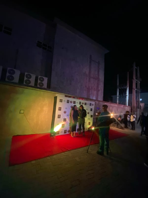 Evening at neon-lit bar in Iranla, Nigeria overlooks cityscape