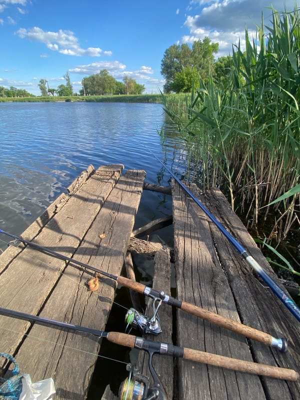 Fishing session documented on wooden dock in Ustyvytsia Ukraine