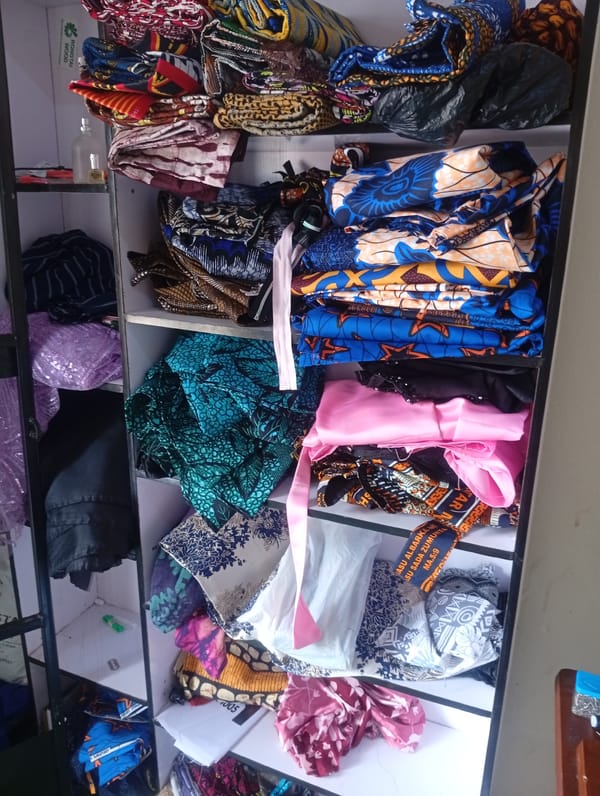 Inside a Jalingo tailor's workspace, fabrics and sewing gear on display