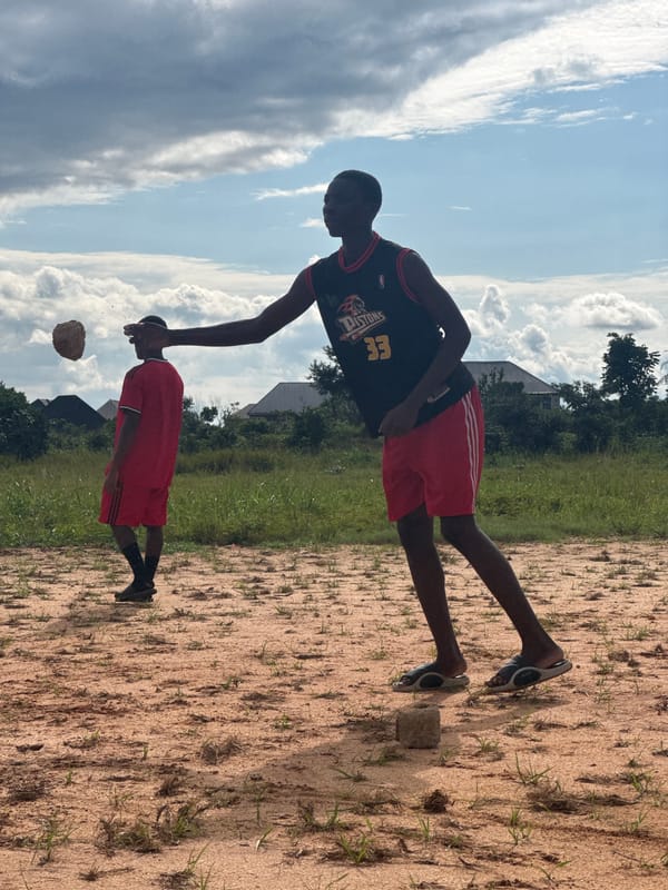 Pickup football on a dusty field in Ihiagwa, Nigeria