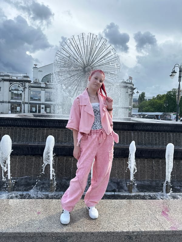 Person in pink outfit walks fountain edge in Saratov