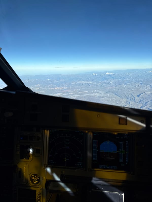 Aircraft flies over mountainous Peru landscape
