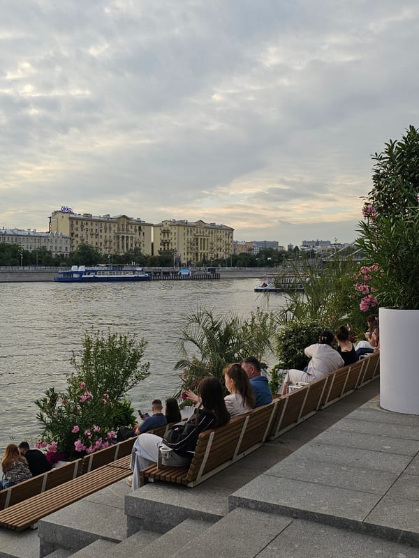 Afternoon along the Moskva River, benches, boats, and dusk skyline