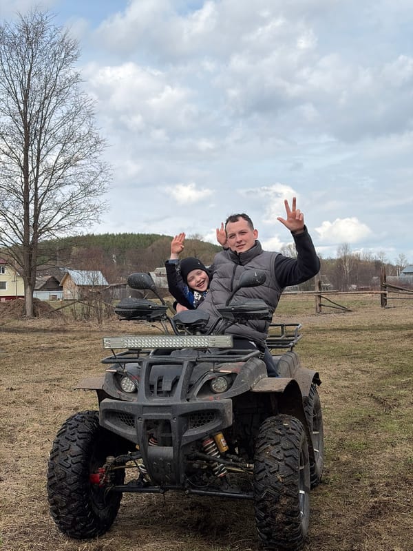 Father and child enjoy ATV ride in Russian countryside