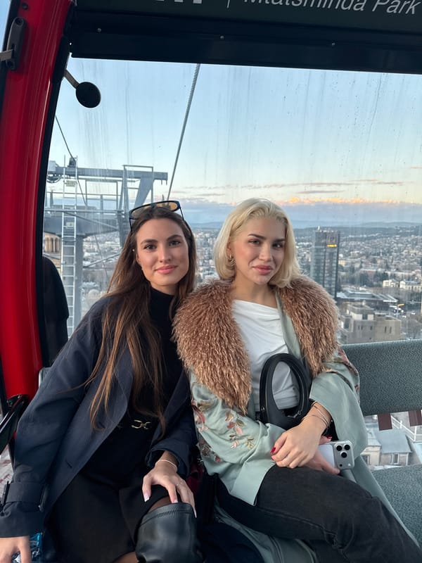 Women ride cable car gondola above Tbilisi