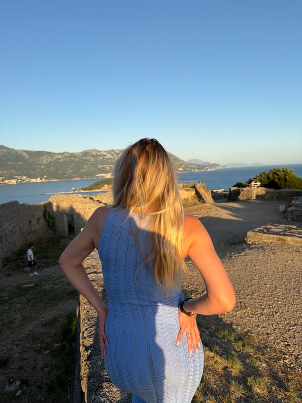 Woman photographed at coastal ruins during Budva golden hour session