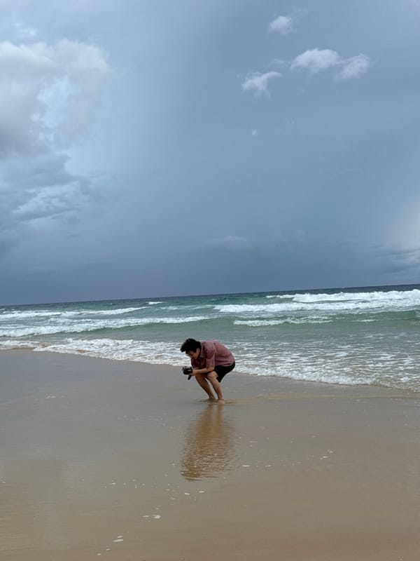 Karon Beach stays busy under stormy skies, flags and all
