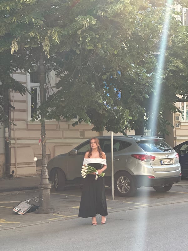 Woman photographed in elevator, street with tulips in Novi Sad