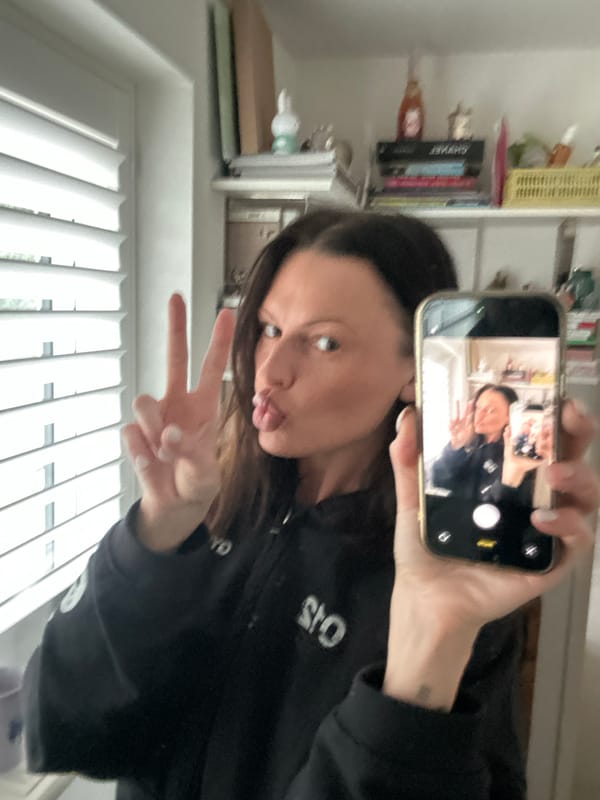 Woman takes selfie with peace sign in Wealden home
