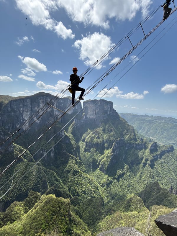 Morning climbers navigate suspension bridges, via ferrata routes in Yongding