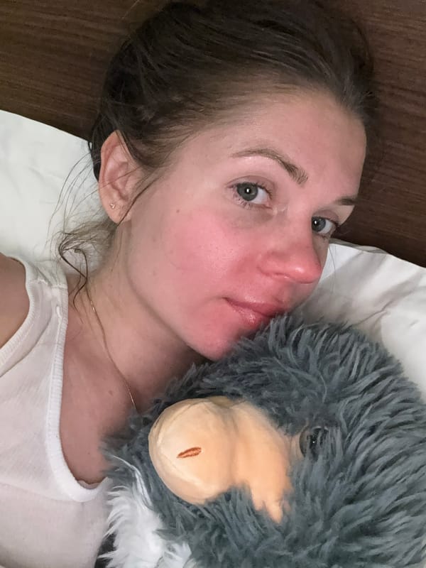 Woman rests on pillow with stuffed animal in Tbilisi