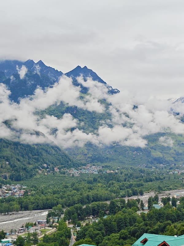 Vashisht village and misty Himalayan peaks on an overcast morning