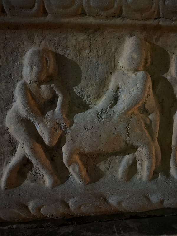 Tourist documents ancient carvings and city views in Budva
