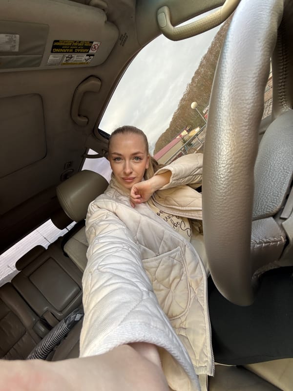 Woman takes selfies in car during evening in Petropavlovsk-Kamchatsky