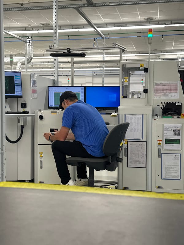 Factory worker watches car wash video on phone during shift