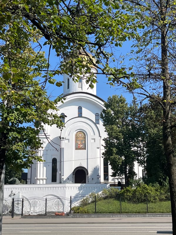 Gold-domed Orthodox church framed by summer greenery in Moscow