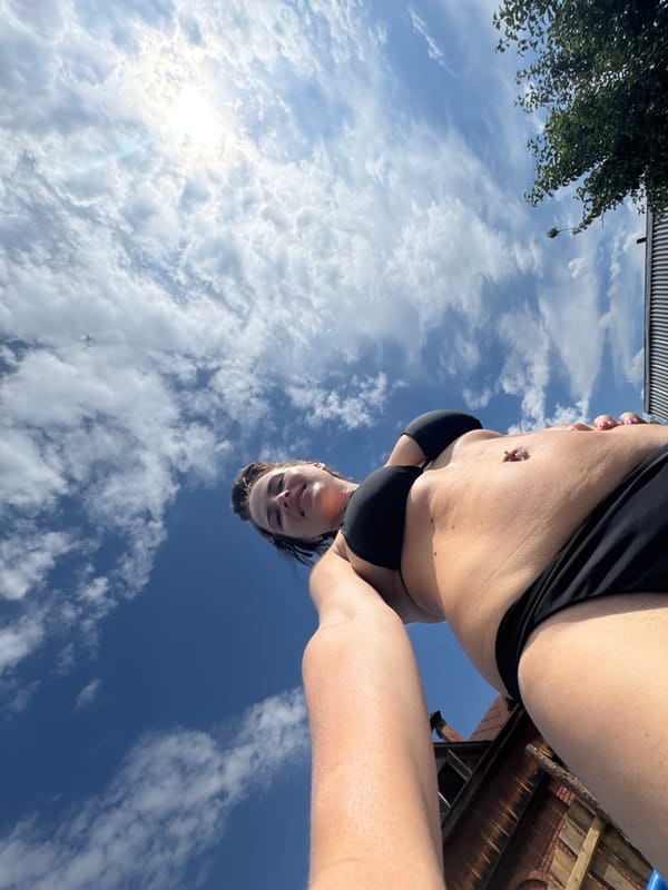 Trampoline lounging next to an inflatable pool on a sunny day