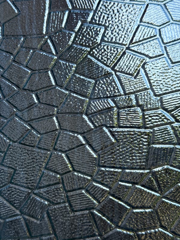 Abstract geometric patterns in textured glass surface