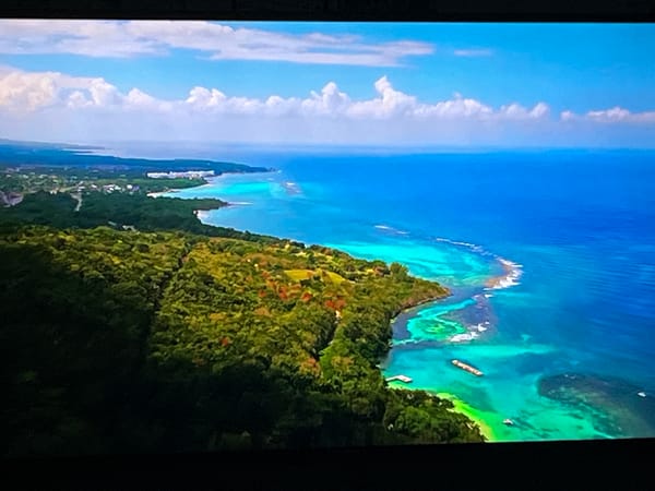Aerial tour of a sun-drenched coastal riviera, likely Albania