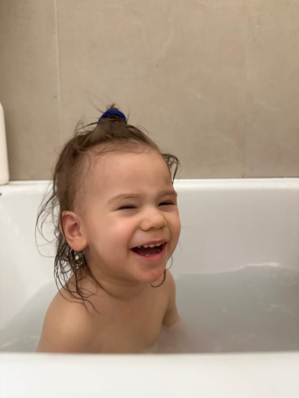 Child enjoys bath time in Kharnavy, Russia