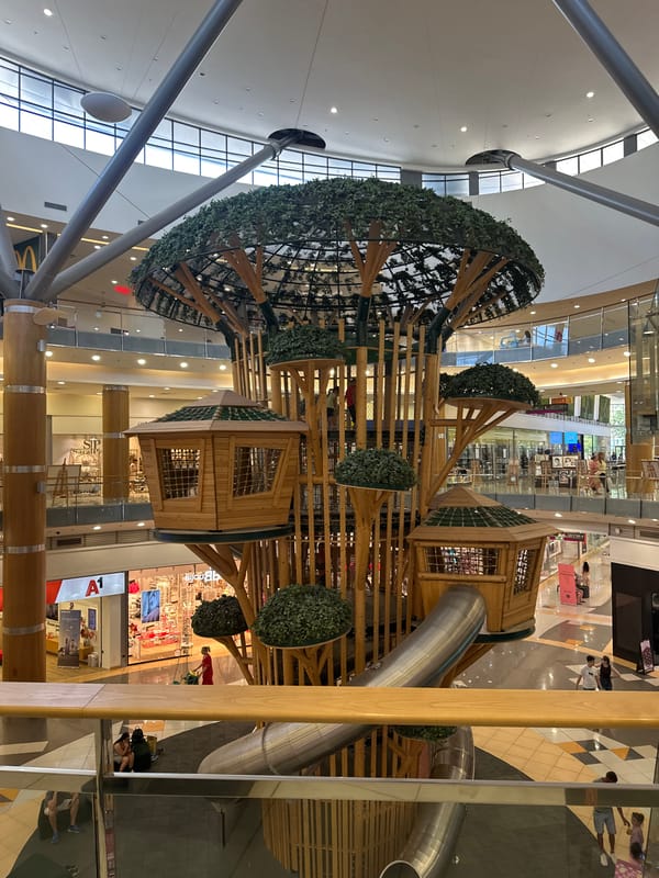 Treehouse play structure fills a shopping mall atrium