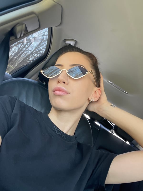 Person rests in car wearing sunglasses in Balvan, Bulgaria
