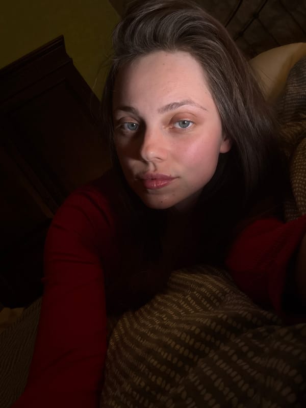 Woman in red shirt resting indoors in Budapest