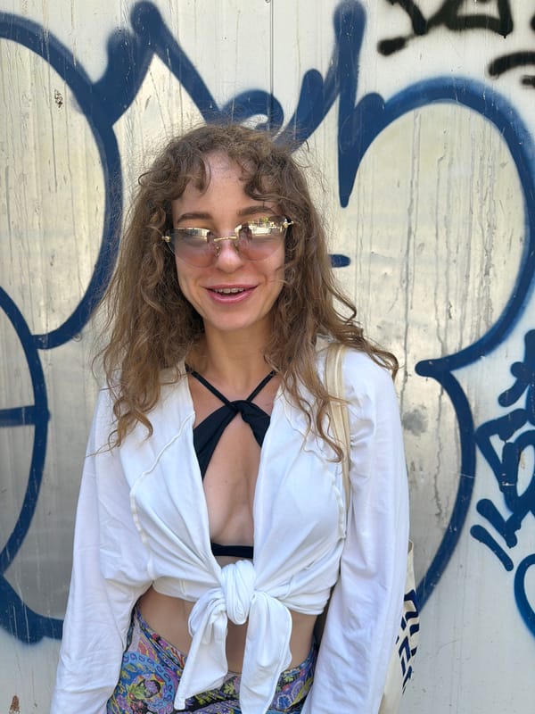 Posing against Tel Aviv's graffiti walls on a summer afternoon