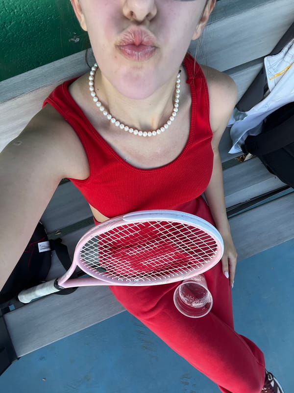 Tennis player takes break on court bleachers in Bulgaria