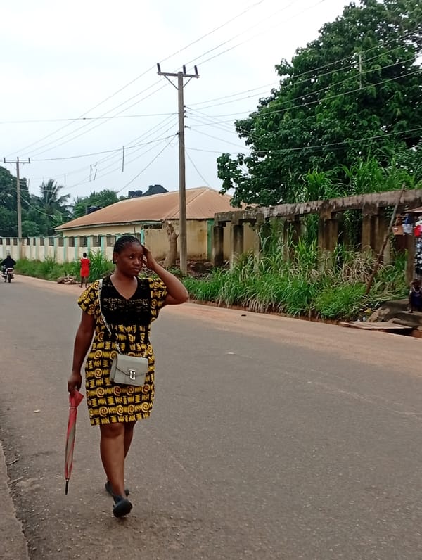 Everyday street life along a paved road in Nsugpe, Nigeria